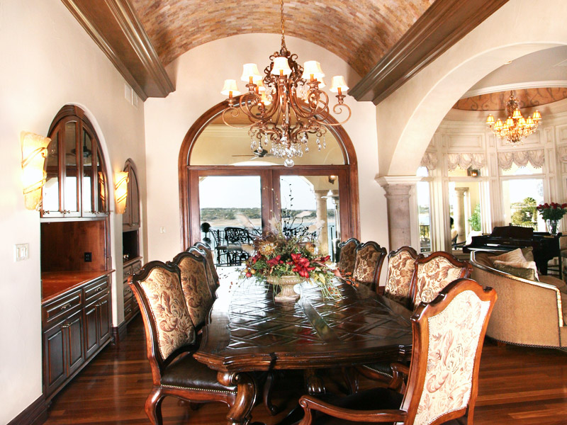 Formal Dining Room with arched barrel ceiling treatment overlooking Lake Travis by Zbranek Holt Custom Homes Lake Travis Custom Home Builder