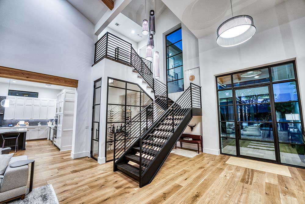Zbranek and Holt Custom Homes Modern Steel and Wood Staircase Wine Room and Glass Entry Over Looking Preserve
