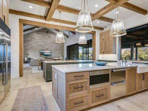 Zbranek and Holts Custom Homes Ranch Style Home Kitchen Island into Living Room Glass Wall Views