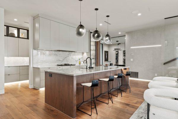 Zbranek Holt LakeLBJ Modern Luxury LakehouseCustom Kitchen Marble Backdrop Walnut Island Sculptural Lighting Design