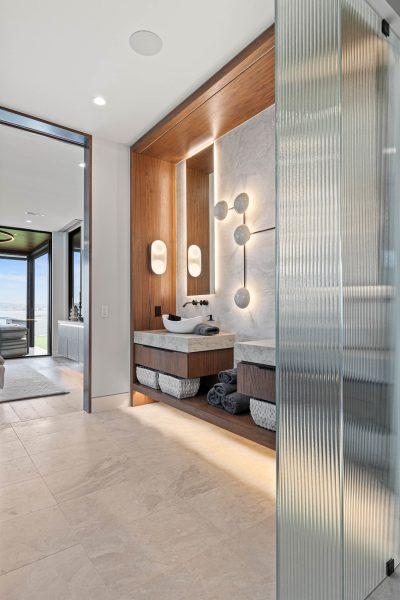 Zbranek Holt LakeLBJ Modern Luxury Lakehouse Bathroom Vanity Wood Paneling Glass Shower