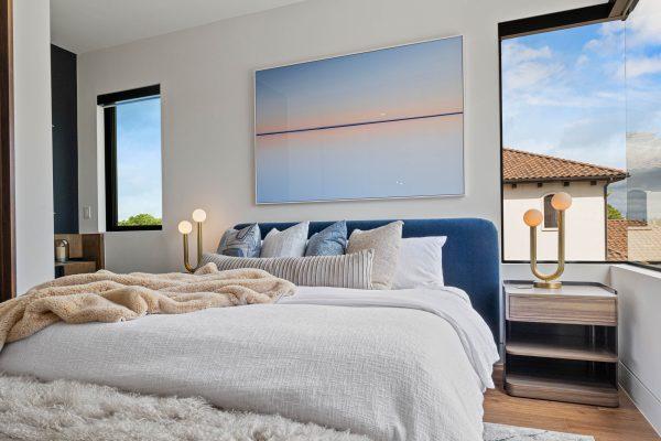 Zbranek Holt LakeLBJ Modern Luxury Lakehouse Bedroom Plush Bedding Corner Windows Cozy Ambiance