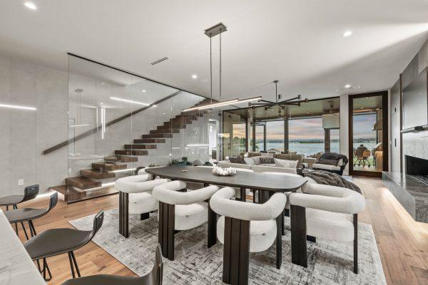 Zbranek Holt LakeLBJ Modern Luxury Lakehouse Dining Area Glass Staircase Water View