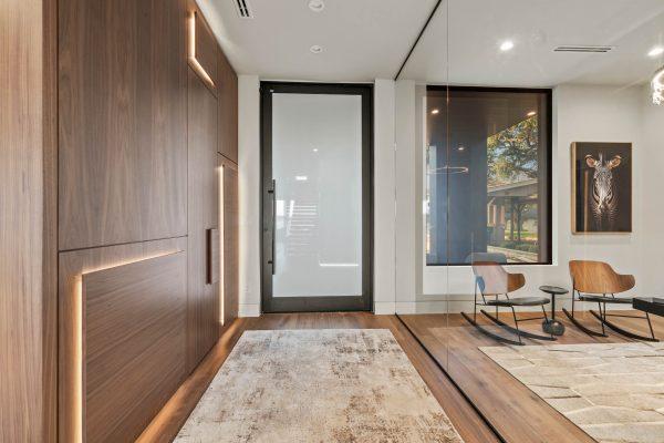 Zbranek Holt LakeLBJ Modern Luxury Lakehouse Entryway Wood Paneling Glass Walls