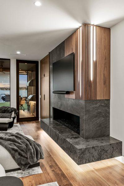 Zbranek Holt LakeLBJ Modern Luxury Lakehouse Fireplace Feature Wood Accent Evening View
