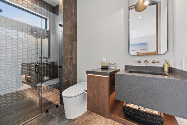 Zbranek Holt LakeLBJ Modern Luxury Lakehouse Guest Bathroom Textured Tile Shower Floating Vanity
