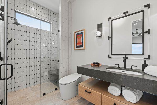 Zbranek Holt LakeLBJ Modern Luxury Lakehouse Guest Bathroom Unique Tile Walk in Shower Black Vanity