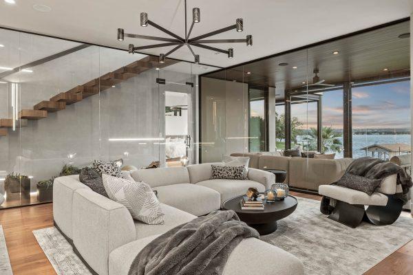 Zbranek Holt LakeLBJ Modern Luxury Lakehouse Living Room Glass Staircase Window Wall Water View