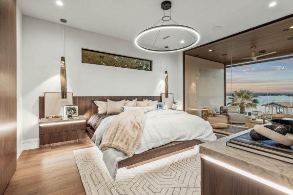 Zbranek Holt LakeLBJ Modern Luxury Lakehouse MasterBedroom Floating Bed Evening View