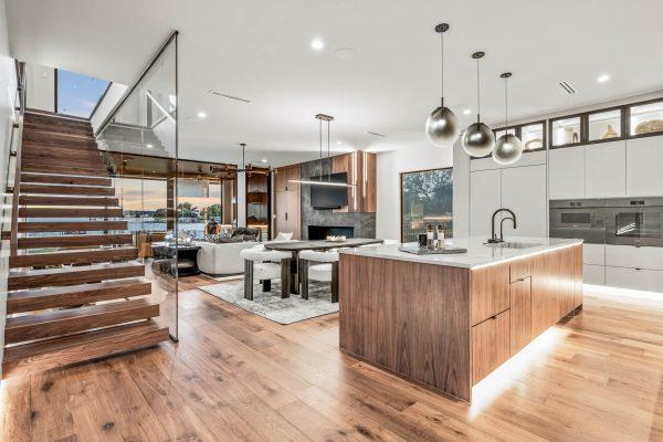 Zbranek Holt LakeLBJ Modern Luxury Lakehouse Open Concept Kitchen Staircase Evening View