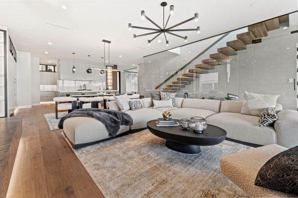 Zbranek Holt LakeLBJ Modern Luxury Lakehouse Open Living Room Kitchen Floating Staircase Glass Railing