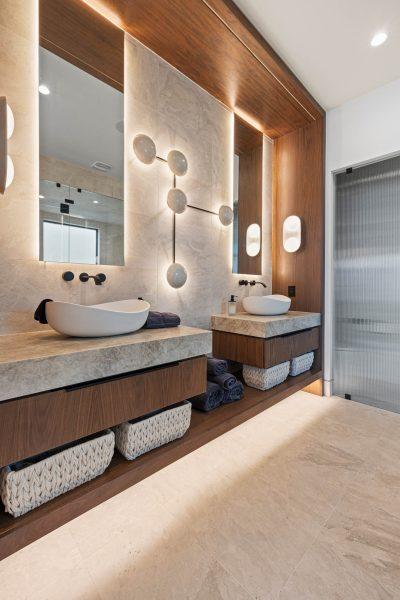 Zbranek Holt LakeLBJ Modern Luxury Lakehouse Primary Bathroom Double Vanity Wood Paneling Backlit Mirrors