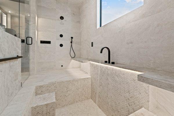 Zbranek Holt LakeLBJ Modern Luxury Lakehouse Primary Bathroom Walk in Shower Soaking Area Backlit Tile