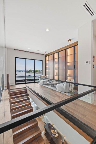Zbranek Holt LakeLBJ Modern Luxury Lakehouse Staircase Landing Reading Nook Lake View Glass Railing