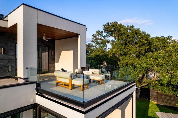 Zbranek Holt Lake LBJ Modern Luxury Lakehouse Upper Terrace View Glass Railing Outdoor Seating