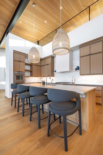 Modern Kitchen Island Wood Cabinetry Pendant Lighting Bar Seating Zbranek and Holt Custom Homes