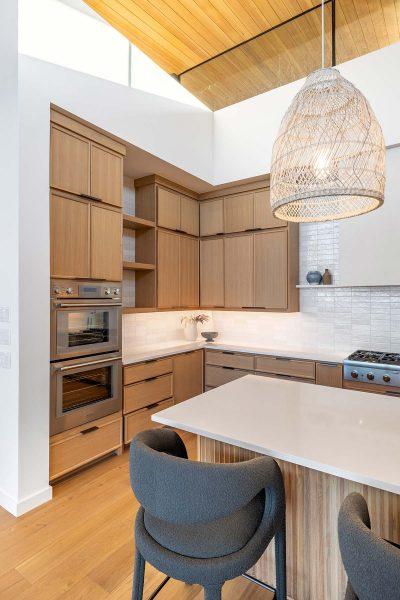 Modern Lakehouse Kitchen Double Ovens Wood Cabinets Pendant Lighting Zbranek and Holt Custom Homes