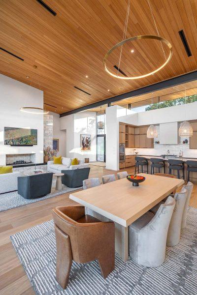 Modern Organic Lakehouse Dining Living Kitchen Wood Ceiling Stone Fireplace Zbranek and Holt Custom Homes