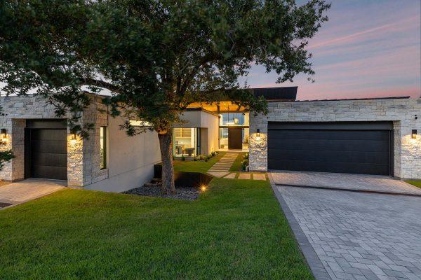 Modern Organic Lakehouse Front Elevation Stone Garage Glass Entry Zbranek and Holt Custom Homes