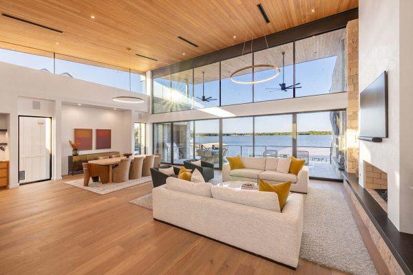 Modern Organic Lakehouse Living Dining Wall of Glass Wood Ceiling Zbranek and Holt Custom Homes