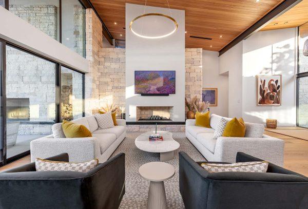Modern Organic Lakehouse Living Room Stone Fireplace Wood Ceiling Glass Walls Zbranek and Holt Custom Homes